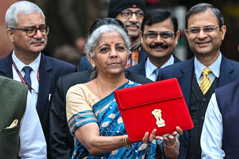 Indian Finance Minister Nirmala Sitharaman with the budget outside the Ministry of Finance in New Delhi on Thursday. Bloomberg