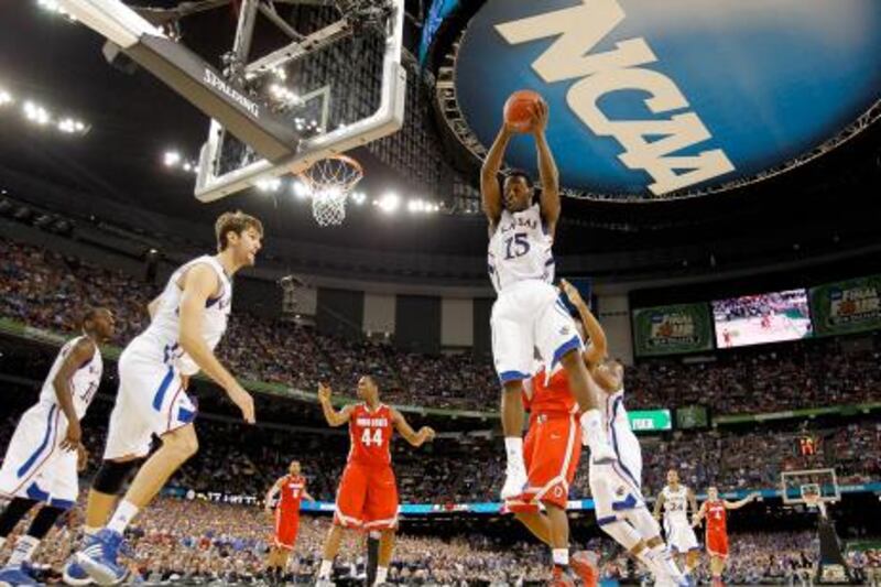 NEW ORLEANS, LA - MARCH 31: Elijah Johnson #15 of the Kansas Jayhawks grabs a rebound in the second half against the Ohio State Buckeyes during the National Semifinal game of the 2012 NCAA Division I Men's Basketball Championship at the Mercedes-Benz Superdome on March 31, 2012 in New Orleans, Louisiana.   Chris Graythen/Getty Images/AFP== FOR NEWSPAPERS, INTERNET, TELCOS & TELEVISION USE ONLY ==
 *** Local Caption ***  215359-01-09.jpg