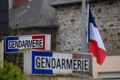 A French flag is seen lowered to half mast on March 24, 2018 at the gendarmerie in Hédé-Bazouges, suburb of Rennes, western France, as a tribute to French Lieutenant Colonel Arnaud Beltrame who was killed the day before after swapping himself for a hostage in a rampage and siege in the town of Trebes.  / AFP PHOTO / DAMIEN MEYER