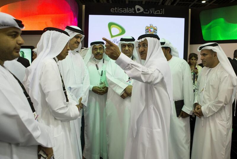 Humaid Mohammed Obaid Al Qatami, the UAE Minister of Education, centre, speaks with Saleh Al Abdooli, the chief executive of Etisalat, during the launch of Duroosi yesterday. Christopher Pike / The National
