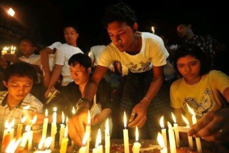 Myanmar demonstrators light candles and pray during a candlelight protest at Sule pagoda against severe power cuts in Yangon yesterday. Soe Than Win / AFP Photo