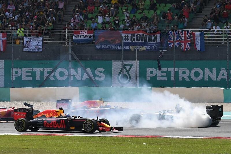 Mercedes-GP driver Nico Rosberg, right, faces the wrong direction after spinning at the start of the race. Manan Vatsyayana / AFP