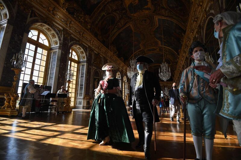 Guests dressed in period costume attend the opening of the Night Fountains Show and the Royal Serenade in the Hall of Mirrors of the Royal Palace of Versailles on the outskirts of Paris. AFP