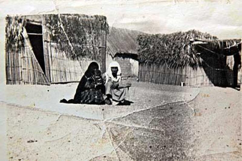 Abdullah bin Khaten, right, and his wife Mozah Mohammed holding her grandaughter Mariam Al Kaabi. They are sitting outside their home made of areesh (date palm) in the Al Faseel neighbourhood of Fujairah in 1970.