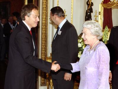 Queen Elizabeth II greeting former British Prime Minister Tony Blair at a reception at Buckingham Palace in London, on July 14, 2004. PA Wire
