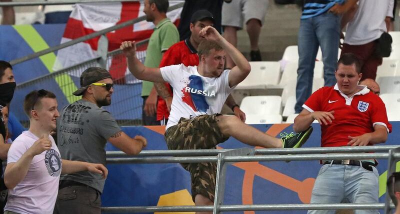 Russian supporters attack an England fan at the end of a Euro 2016 game.  Thanassis Stavrakis / AP