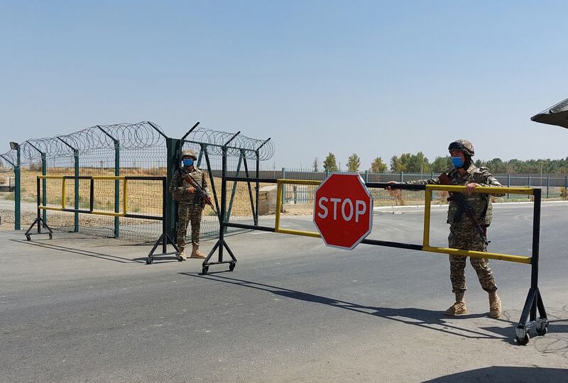 Uzbek soldiers guard a checkpoint two kilometres from the river that separates Uzbekistan and Afghanistan. AFP