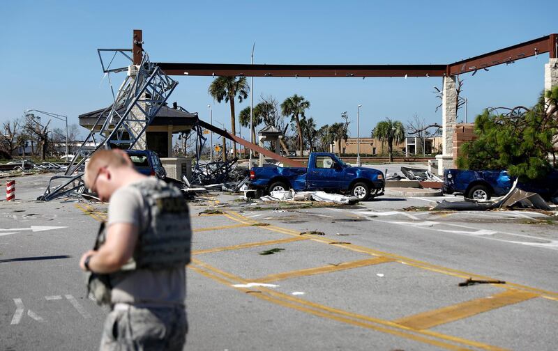 A soldier stands guard at the damaged entrance to Tyndall Air Force Base in Panama City. AP Photo