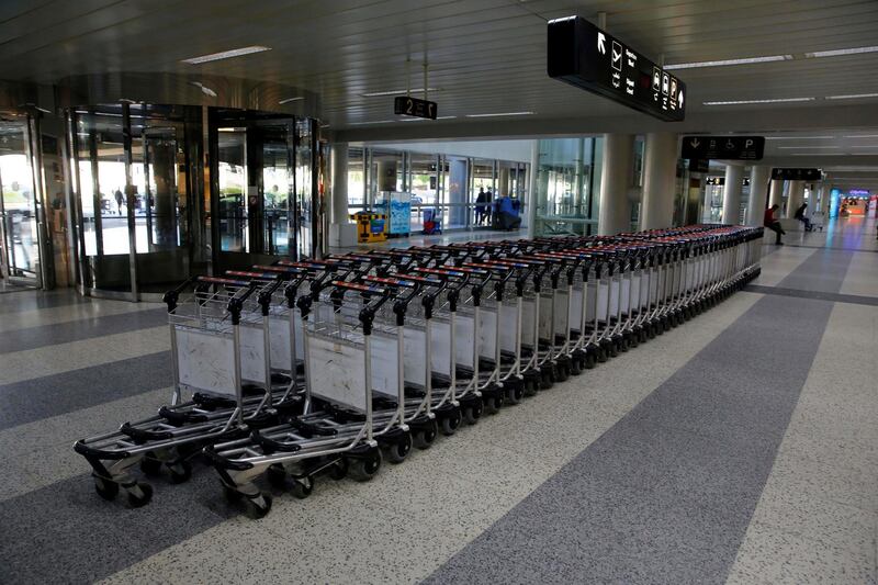 Airport trollies lined in the almost empty arrival hall of the Rafik Hariri International Airport during a strike in Beirut, Lebanon, Friday, Jan. 4, 2019. Parts of Lebanon's public and private sectors have gone into a strike called for by the country's labor unions to protest worsening economic conditions and months of delays in the formation of a new government. (AP Photo/Bilal Hussein)