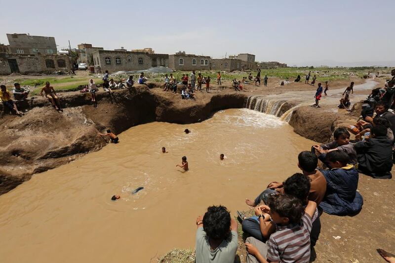 Yemenis swimming in floodwaters following heavy rains in Sanaa, Yemen. Yahya Arhab / EPA