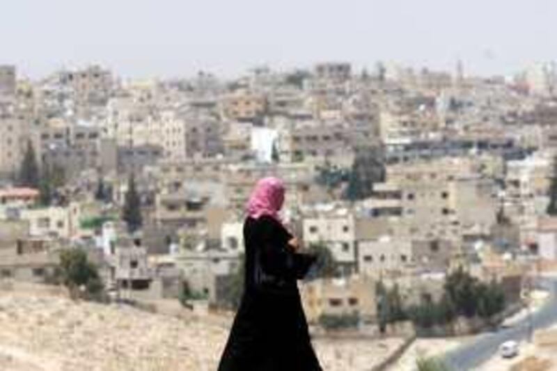 A Woman takes her way in front of al-Jabal al-Shamali , a Jordanian neighborhood that became of Palestinian majority after 1990 while it's native residents "Bani Hasan" are among the biggest tribals of Jordan, on June 02, 2009. (Salah Malkawi/ The National)