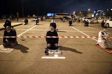 Palestinian and Arab Israeli men keep a 2-meter distance amid the Covid-19 pandemic, as they pray in a parking lot near the beach in Jaffa, near the Israeli coastal city of Tel Aviv after breaking their fast, on the second day of the Muslim holy month of Ramadan, on April 25, 2020. AFP