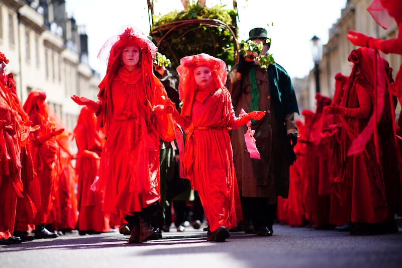 Red Rebels take part in a Funeral for Nature procession to mark the decline of the natural world, before Earth Day, in Bath. AP