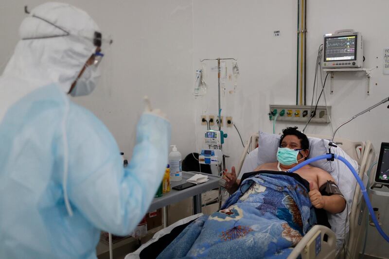 Dr Alberto Ortiz, the head of the Covid-19 intensive care unit, gives a thumbs up to a patient who is improving at Ineram Hospital in Asuncion, Paraguay. AP Photo