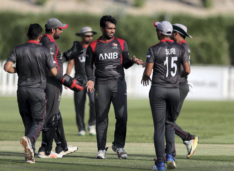 Abu Dhabi, United Arab Emirates - October 22, 2018: Amir Hayat (M) of the UAE takes the wicket of Chris Lynn of Australia in the match between the UAE and Australia in a T20 international. Monday, October 22nd, 2018 at Zayed cricket stadium oval, Abu Dhabi. Chris Whiteoak / The National