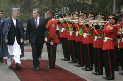 Former Afghan and UK leaders Hamid Karzai and Gordon Brown inspect a guard of honour in Kabul in 2009. Getty 