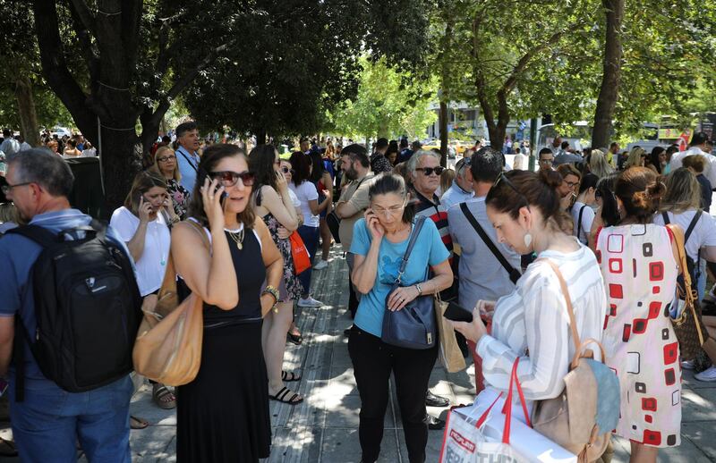 People are seen on the Syntagma Square following the evacuation of nearby buildings after an earthquake in Athens, Greece, July 19, 2019. REUTERS/Alkis Konstantinidis