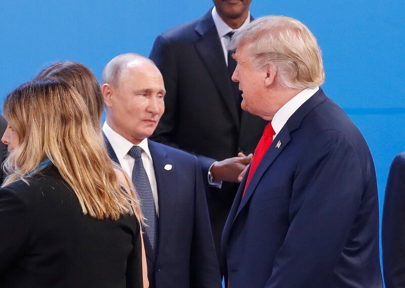 FILE - In this Nov. 30, 2018, file photo, President Donald Trump, right, walk past Russia's President Vladimir Putin, left, as they gather for the group photo at the start of the G20 summit in Buenos Aires, Argentina. The pullout of U.S. troops from Syria ordered by President Donald Trump could further bolster Moscowâ€™s clout in Syria, but it may also destabilise Russia's standing in the region. ( (AP Photo/Pablo Martinez Monsivais, File)