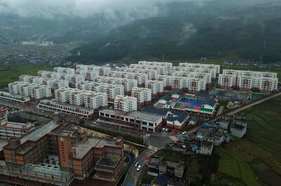 An aerial view shows apartments built by the Chinese government for ethnic minority in Yuexi county, southwest China's Sichuan province on Sept. 11, 2020. The ruling Communist Party says its initiatives have helped to lift millions of people out of poverty. Yi ethnic minority members were moved out of their mountain villages in Chinaâ€™s southwest and into a newly built town in an anti-poverty initiative. (AP Photo/Sam McNeil)