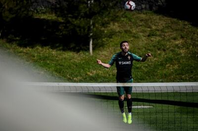 Portugal's midfielder Bernardo Silva heads the ball during a training session at "City of Football" training camp in Oeiras, outskirts of Lisbon on March 19, 2019 ahead of the Euro 2020 qualifying match Portugal vs Ukraine. / AFP / PATRICIA DE MELO MOREIRA
