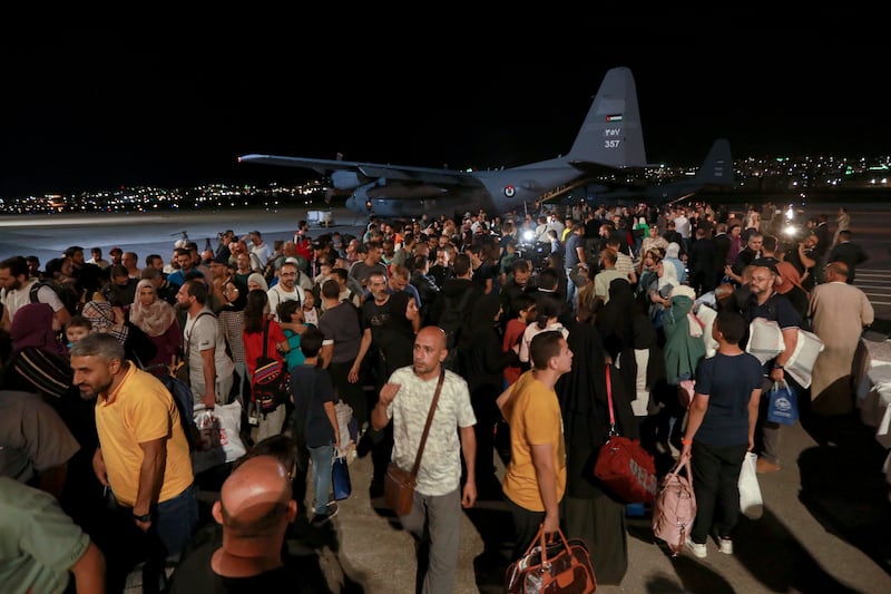 Jordanians arrive at a military airport in Amman after their evacuation from Sudan to escape the fighting. AP 