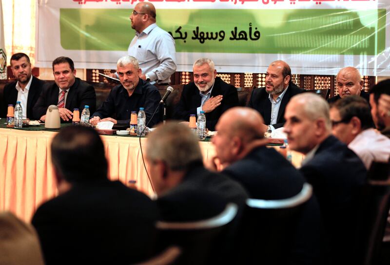 Senior political leader Ismail Haniyeh (4L) and Yahya Sinwar (3L) the new leader of the Hamas Islamist movement in the Gaza Strip attend a meeting with leaders of Palestinian factions in Gaza City on September 25, 2017. / AFP PHOTO / MAHMUD HAMS