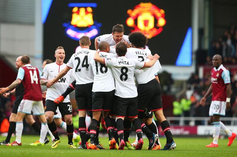 Wayne Rooney and his Manchester United teammates celebrate after his 58-yard opening goal on Saturday. Julian Finney / Getty Images/ March 22, 2014