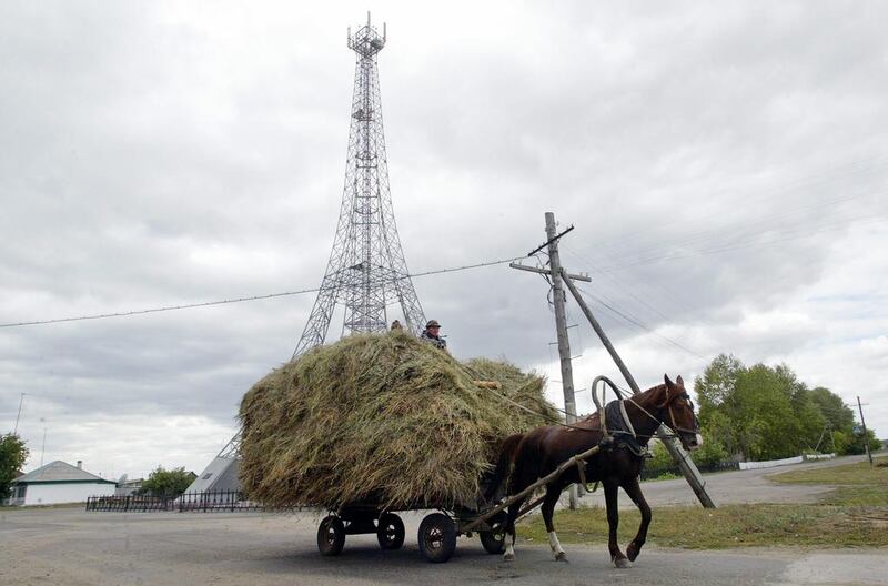 A horse-drawn cart passes the Eiffel Tower in the Parizh settlement in Russia’s Chelyabinsk Region.