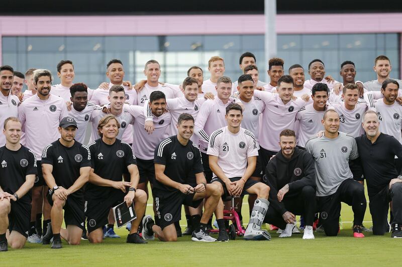 Head coach Diego Alonso, owner and president of soccer operations David Beckham, and owner Jorge Mas of Inter Miami pose for a photo with the team. AFP