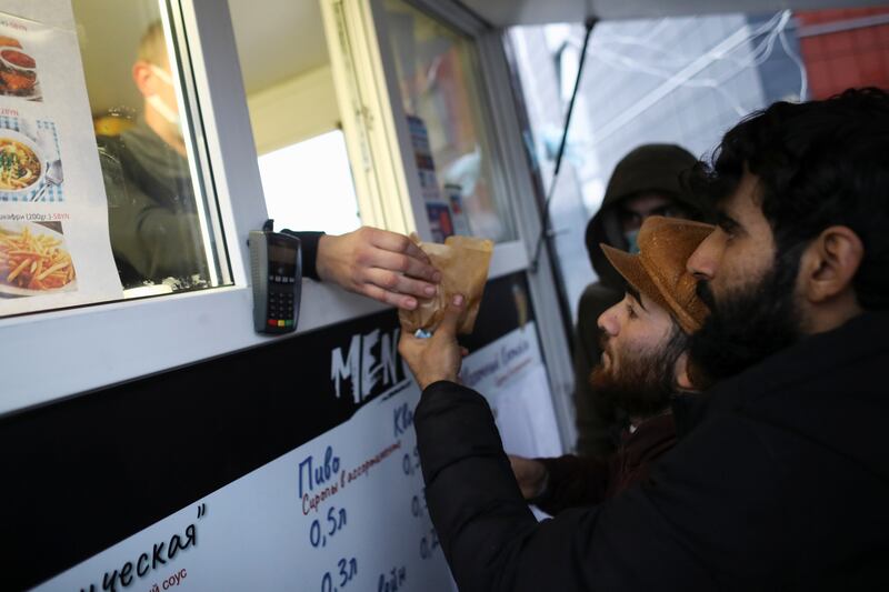 Migrants receive food near the border in the Grodno region. Reuters