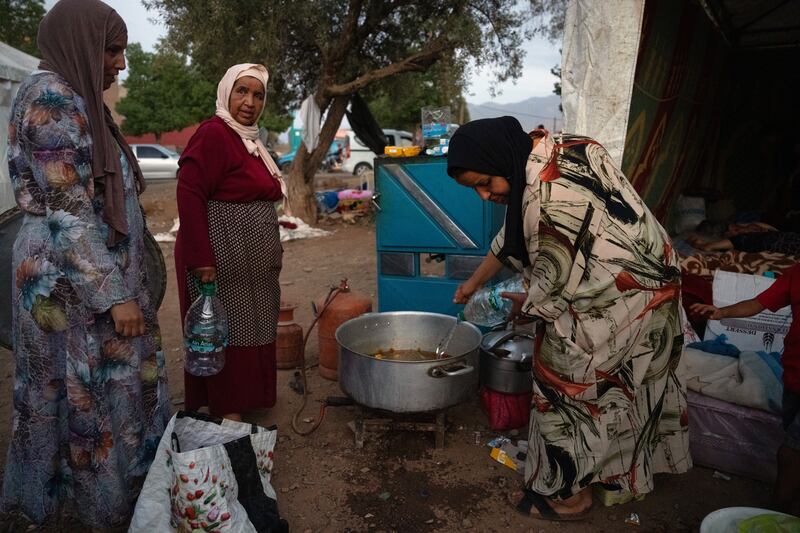 Women make soup outside a tent in Amizmiz, Morocco, after being displaced by Friday's earthquake. Getty Images