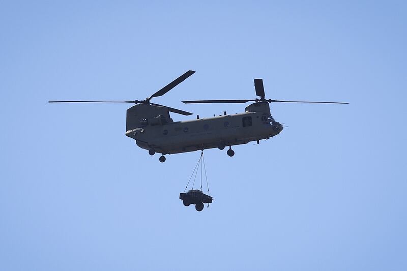 A Chinook helicopter carries an industrial generator to Pine Island. Getty / AFP