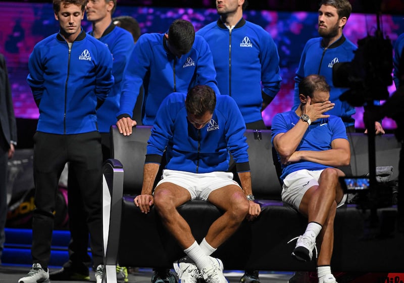 Roger Federer and Rafael Nadal wipe away their tears in London. AFP