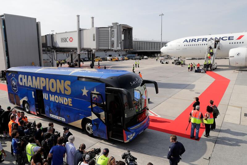 A bus is parked in front of the plane transporting the France's national football team at the Charles de Gaulle Airport. Thomas Samson / AFP