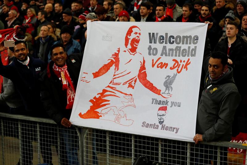 Soccer Football - Premier League - Liverpool vs Leicester City - Anfield, Liverpool, Britain - December 30, 2017   Liverpool fans with a banner welcoming Virgil Van Dijk to the club before the match   REUTERS/Phil Noble    EDITORIAL USE ONLY. No use with unauthorized audio, video, data, fixture lists, club/league logos or "live" services. Online in-match use limited to 75 images, no video emulation. No use in betting, games or single club/league/player publications.  Please contact your account representative for further details.