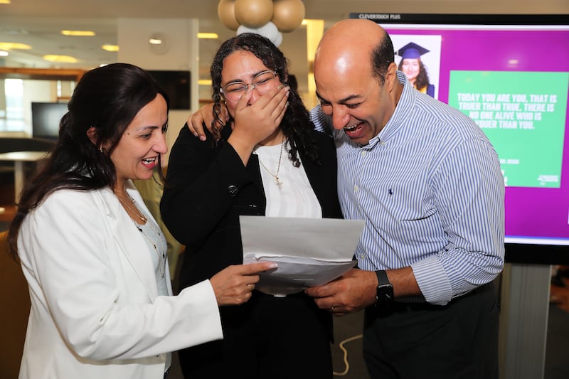 Karen Youakim celebrating with her parents after getting the IB in Silicon Oasis in Dubai. Pawan Singh / The National