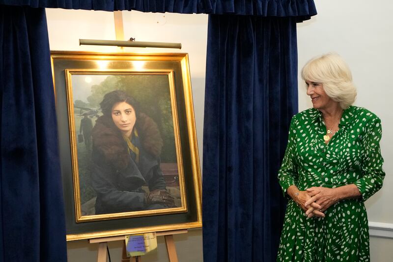 LONDON, ENGLAND - AUGUST 29: Britain's Queen Camilla unveils a portrait of SOE Operative, Noor-un-Nisa Inayat Khan GC, at the Royal Air Force Club on August 29, 2023 in London, England. Queen Camilla unveiled a portrait of SOE Operative, Noor-un-Nisa Inayat Khan GC, and formally announced the name of a room in her honor at the Royal Air Force Club. (Photo by Kirsty Wigglesworth - WPA Pool  /  Getty Images)