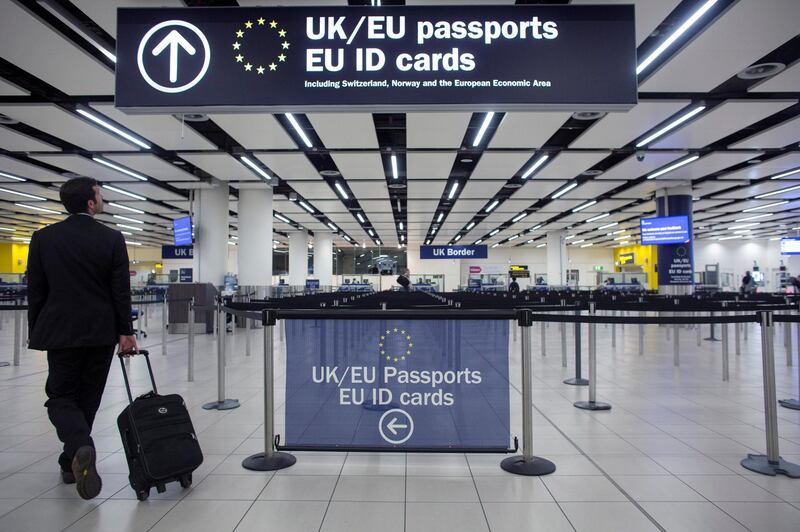 LONDON, ENGLAND - MAY 28:  Border Force check the passports of passengers arriving at Gatwick Airport on May 28, 2014 in London, England. Border Force is the law enforcement command within the Home Office responsible for the security of the UK border by enforcing immigration and customs controls on people and goods entering the UK. Border Force officers work at 140 sea and airports across the UK and overseas.  (Photo by Oli Scarff/Getty Images)