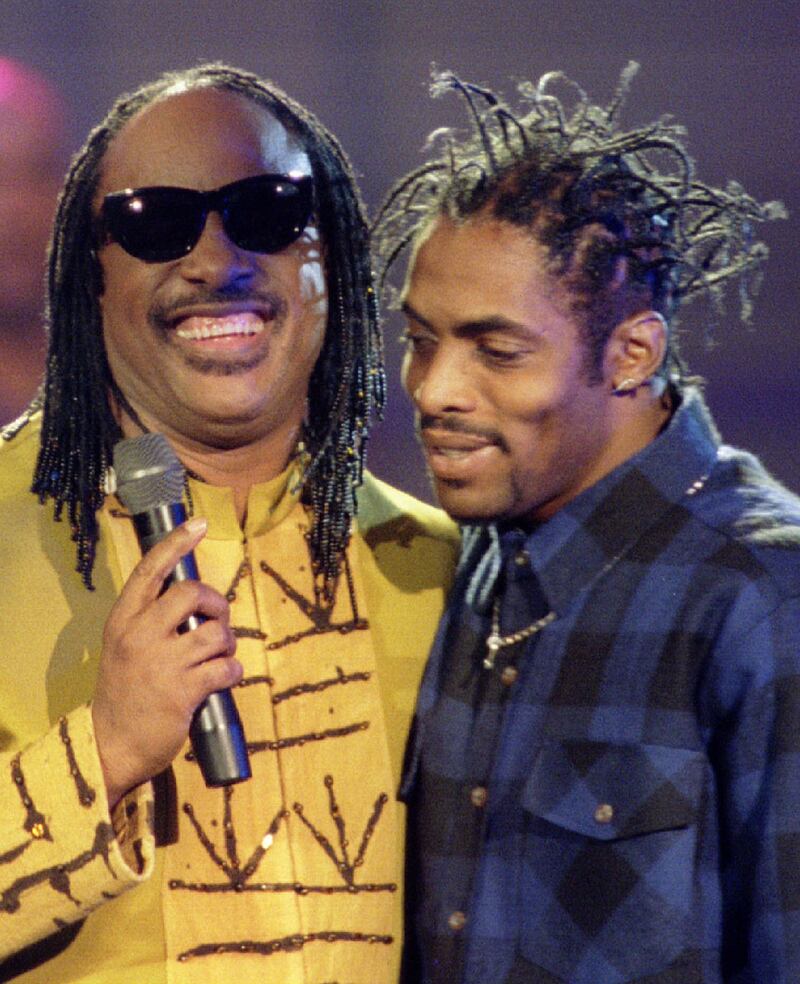 Stevie Wonder performs with Coolio in 1995, when the rapper won the Billboard Music Award for best single. Reuters