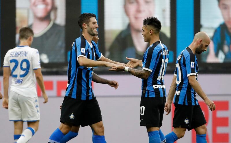 Inter Milan's Roberto Gagliardini, left, celebrates with teammate Lautaro Martinez after scoring his side's fourth goal. AP Photo
