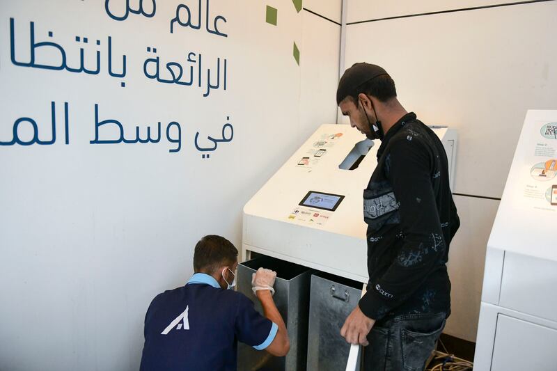 Rabi Rayrajput, who works in housekeeping at World Trade Centre Mall, empties the Cycle machine.