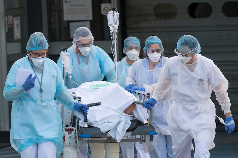 Medical staff push a patient on a gurney to a waiting medical helicopter at the Emile Muller hospital in Mulhouse, eastern France. AFP