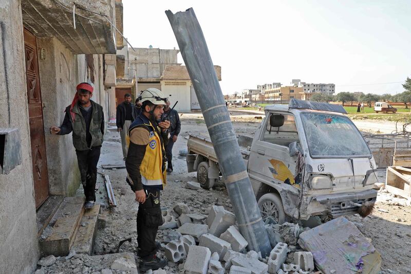 TOPSHOT - Syrians stand next to a russian made missile after an airstrike in the town Sarmin in the northern Idlib province on March 12, 2019. / AFP / OMAR HAJ KADOUR
