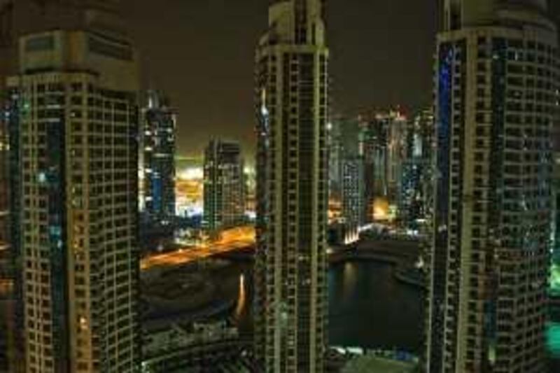 United Arab Emirates - Dubai - March. 15, 2009:

STOCK: Unfinished buildings face the Dubai Marina and adjacent Jumeirah Lake Towers in Dubai on Saturday, March 15, 2009. Amy Leang/The National  
 *** Local Caption ***  amy_031509_nightdubai_02.jpg amy_031509_nightdubai_02.jpg