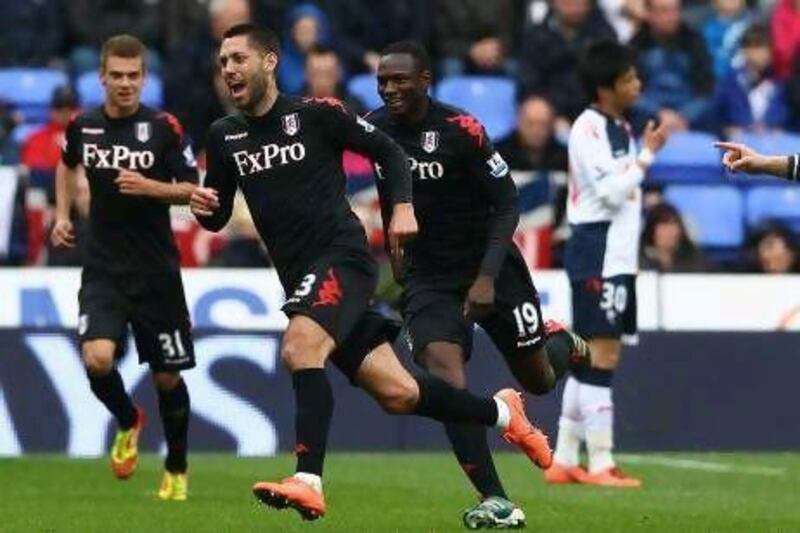 Clint Dempsey, second left, wheels away in celebration after scoring the first of his two goals in a rare 3-0 away win for Fulham at Bolton Wanderers yesterday. Clive Brunskill / Getty Images