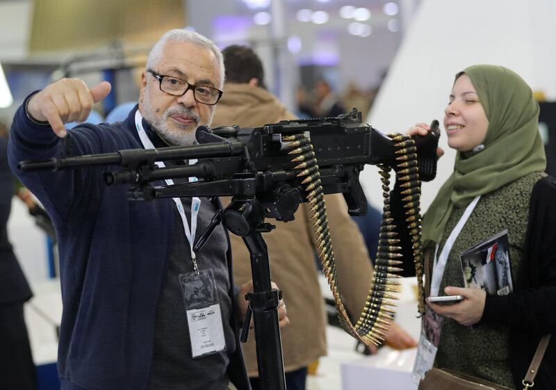 A visitor shows a weapon at the Egyptian stand during the last day of Egypt Defence Expo, showcasing military systems and hardware, in Cairo, Egypt. Reuters