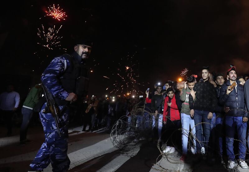 An Iraqi policeman stands guard as Iraqis celebrate the New Year in Baghdad.  AFP