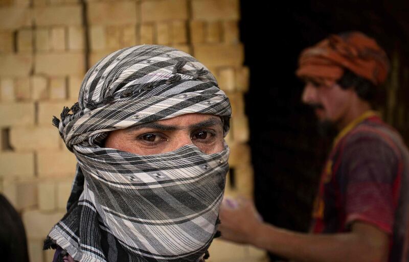 A worker poses for a picture at the brickmaking factory.  AFP