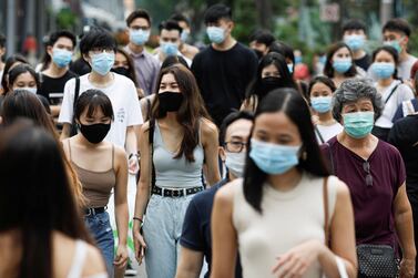 FILE PHOTO: People cross a street in the shopping district of Orchard Road in Singapore amid the coronavirus disease (COVID-19) outbreak, on June 19, 2020. REUTERS/Edgar Su/File Photo