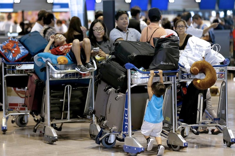 Passengers line up at the Delta Air Lines for check-in counter at Narita international airport. Shizuo Kambayashi / AP Photo